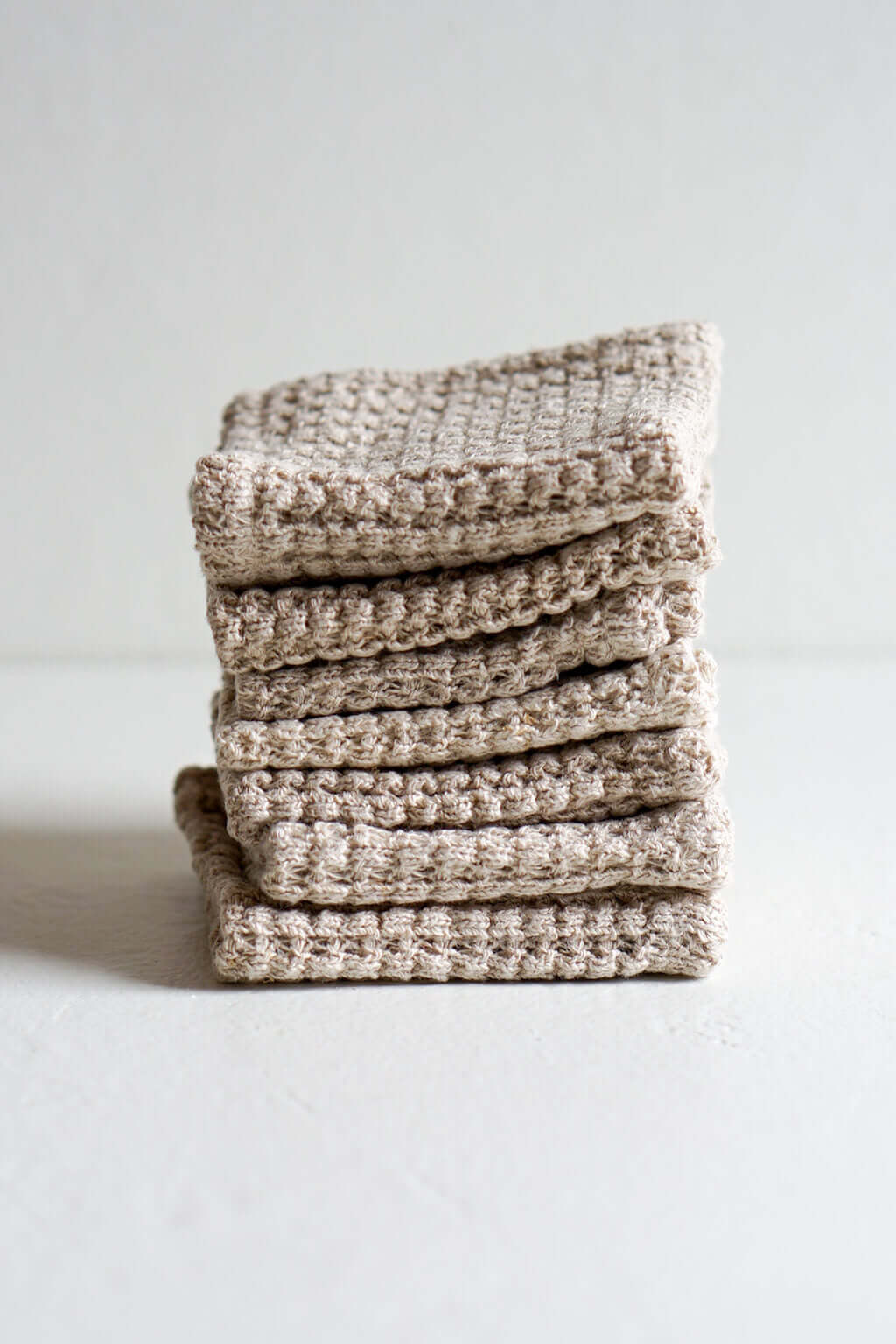 Stack of hadcrafted natural hemp washcloths for kitchen and bath