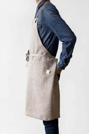 Side profile of natural linen apron with leather neck strap