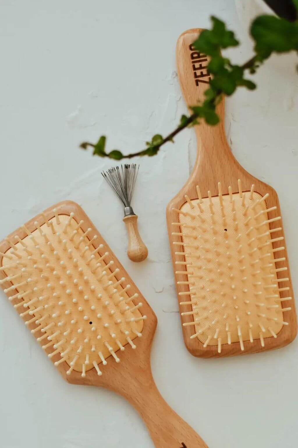 Hairbrush cleaner with natural wood handle and metal tines